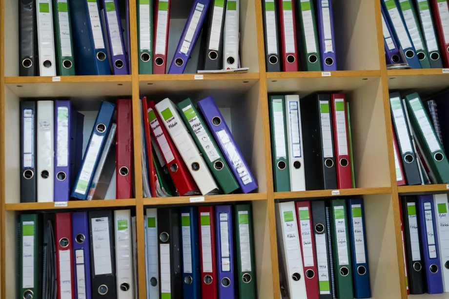 Office shelves filled with colourful binders and folders